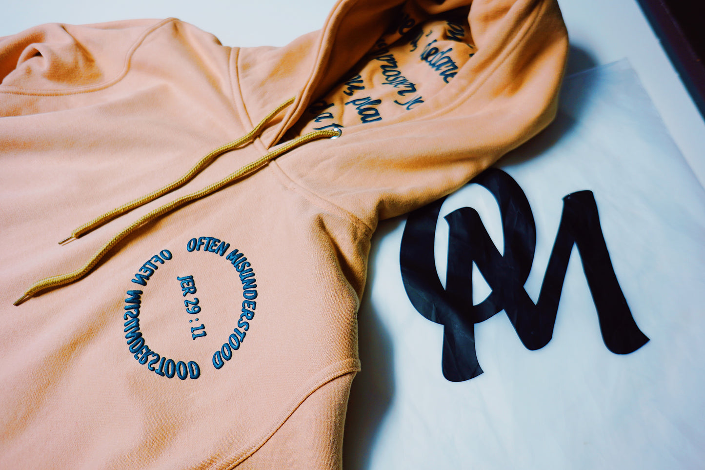 OM “God’s Timing Is the Best Timing” Hoodie – Desert Peach / Teal Puff Print